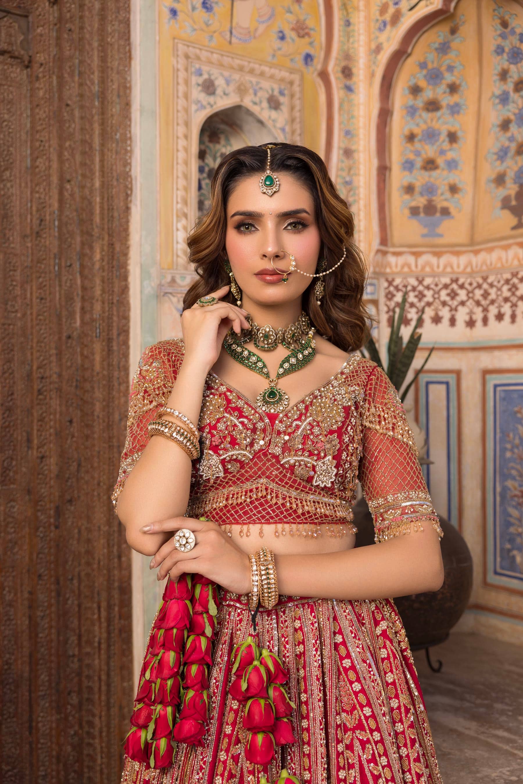 A bride in a painted alcove, hand at her chin