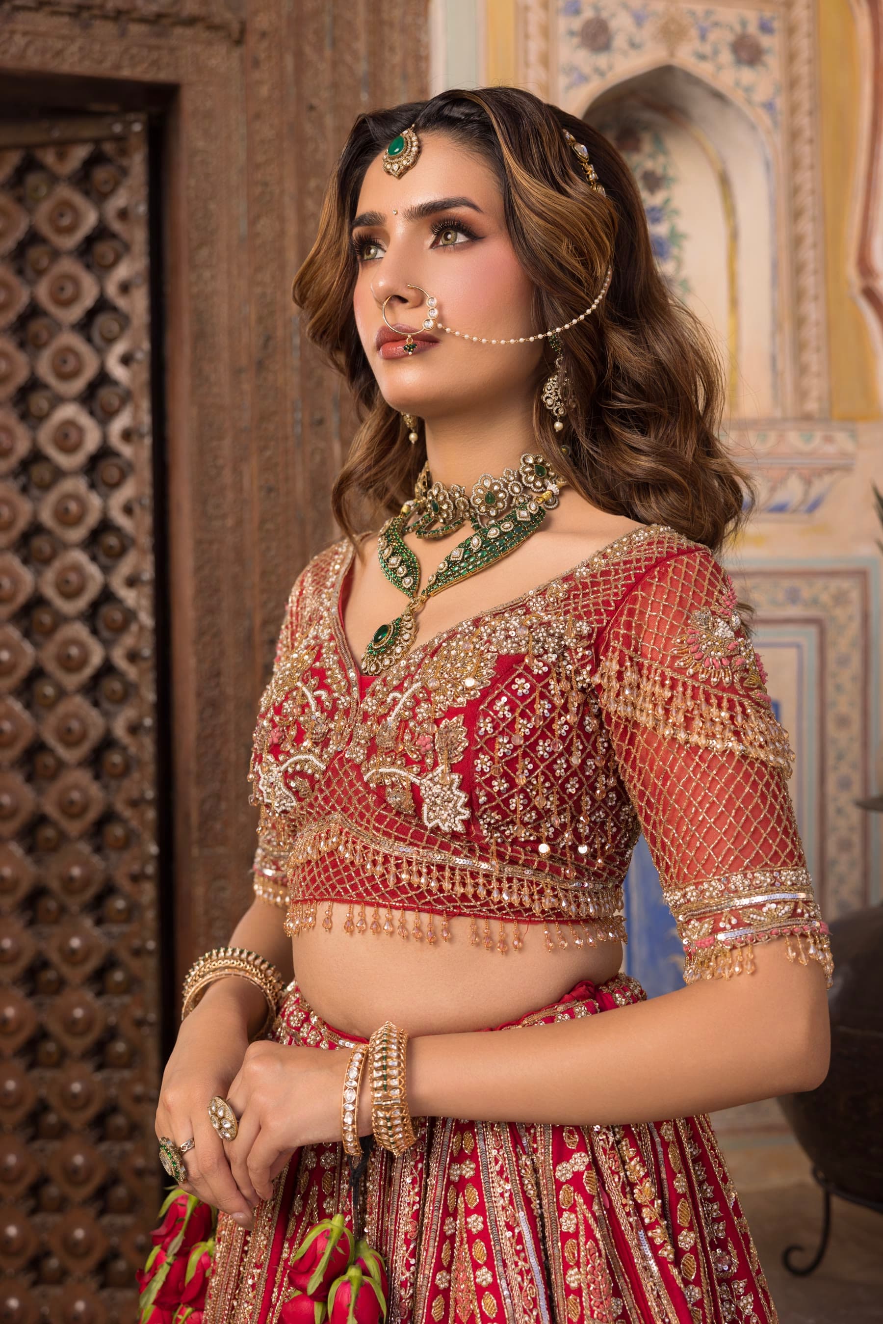 A bride looking away from the camera, carved door behind