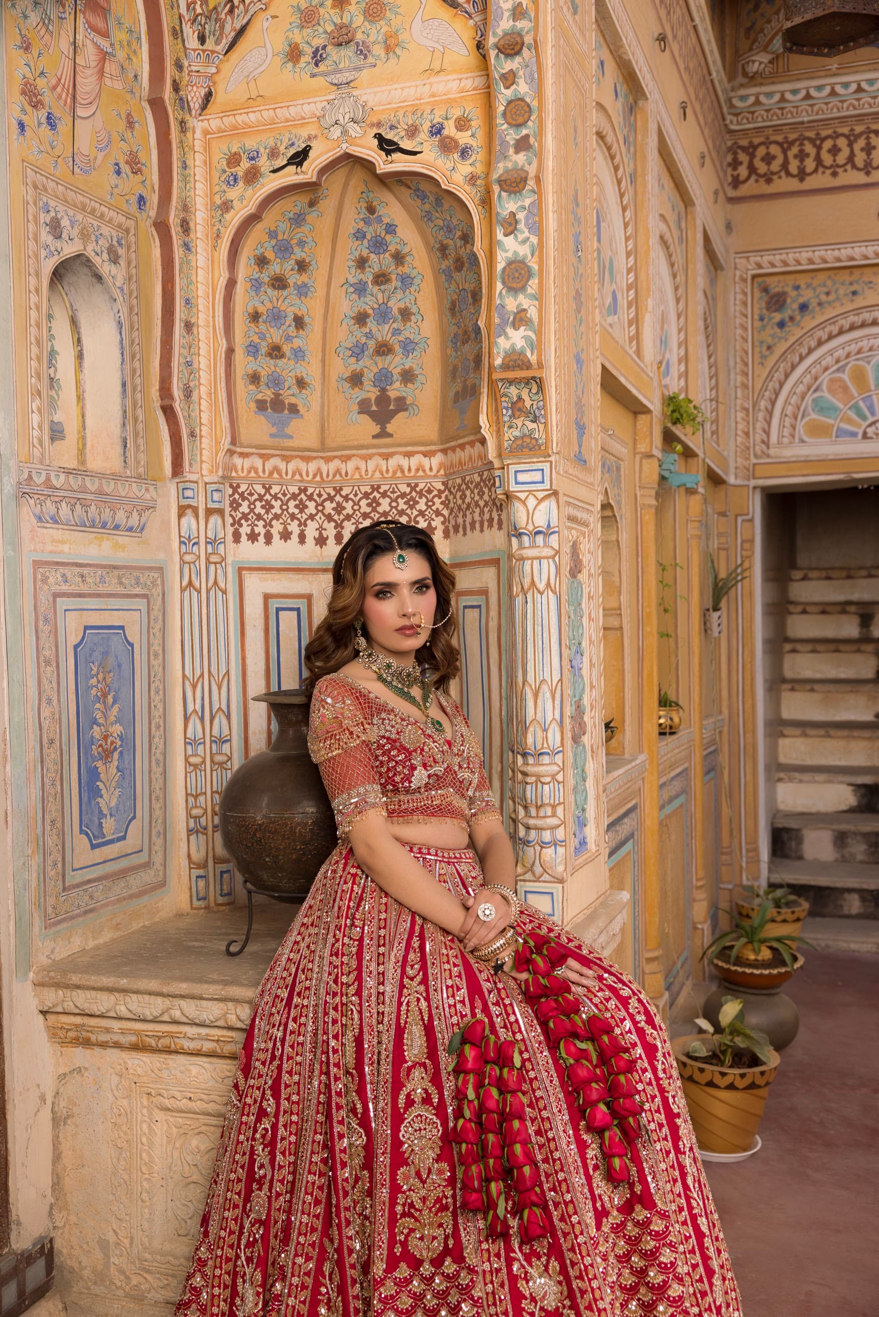 A bride standing full length in the courtyard