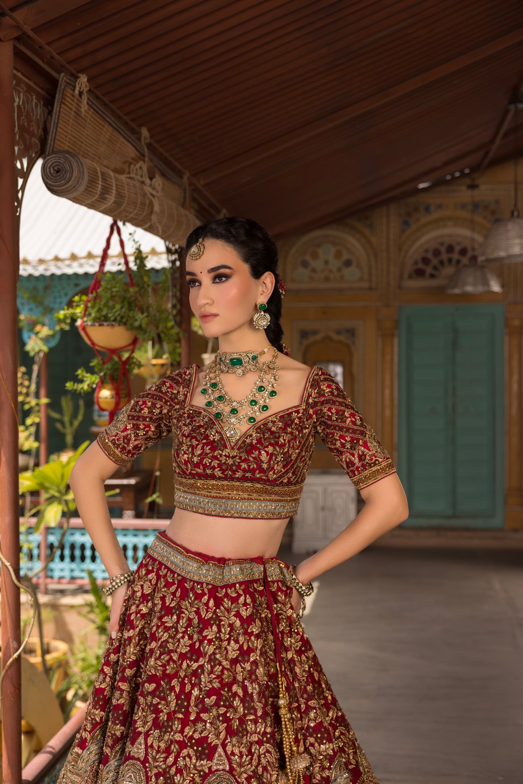 A bride on the veranda, one hand at her waist