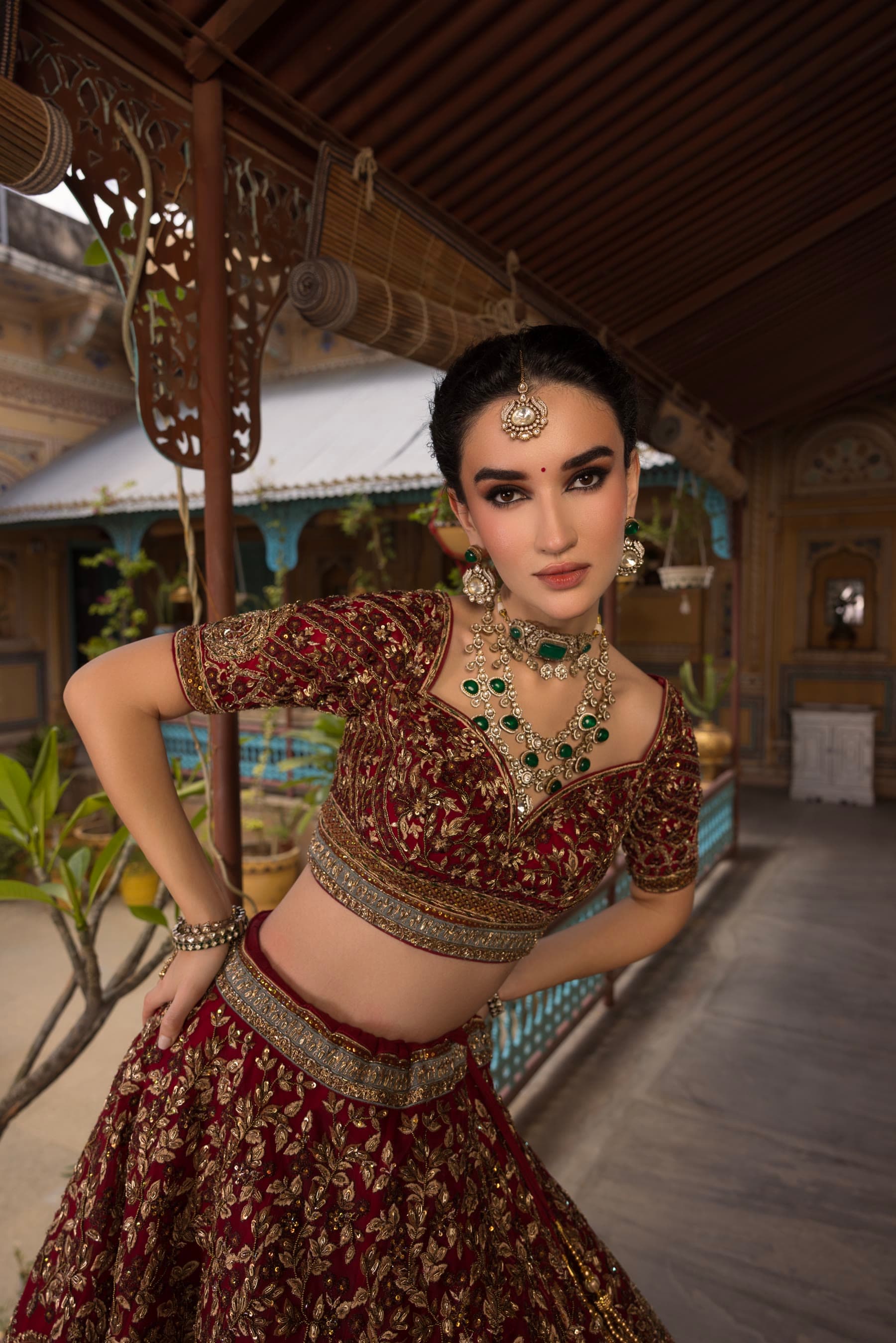 A bride leaning against a veranda post